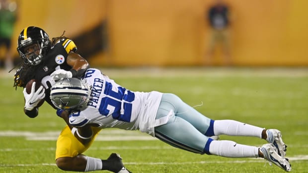 Aug 5, 2021; Canton, Ohio, USA; Dallas Cowboys defensive back Steven Parker (25) tackles Pittsburgh Steelers running back Anthony McFarland (26) during the second half at Tom Benson Hall of Fame Stadium.